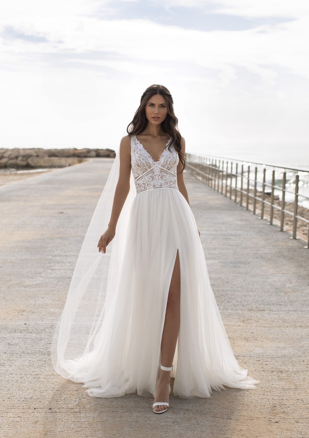 hochzeitsrausch Brautmoden - Elegantes Brautkleid mit Spitzenoberteil und hohem Beinschlitz am Strand